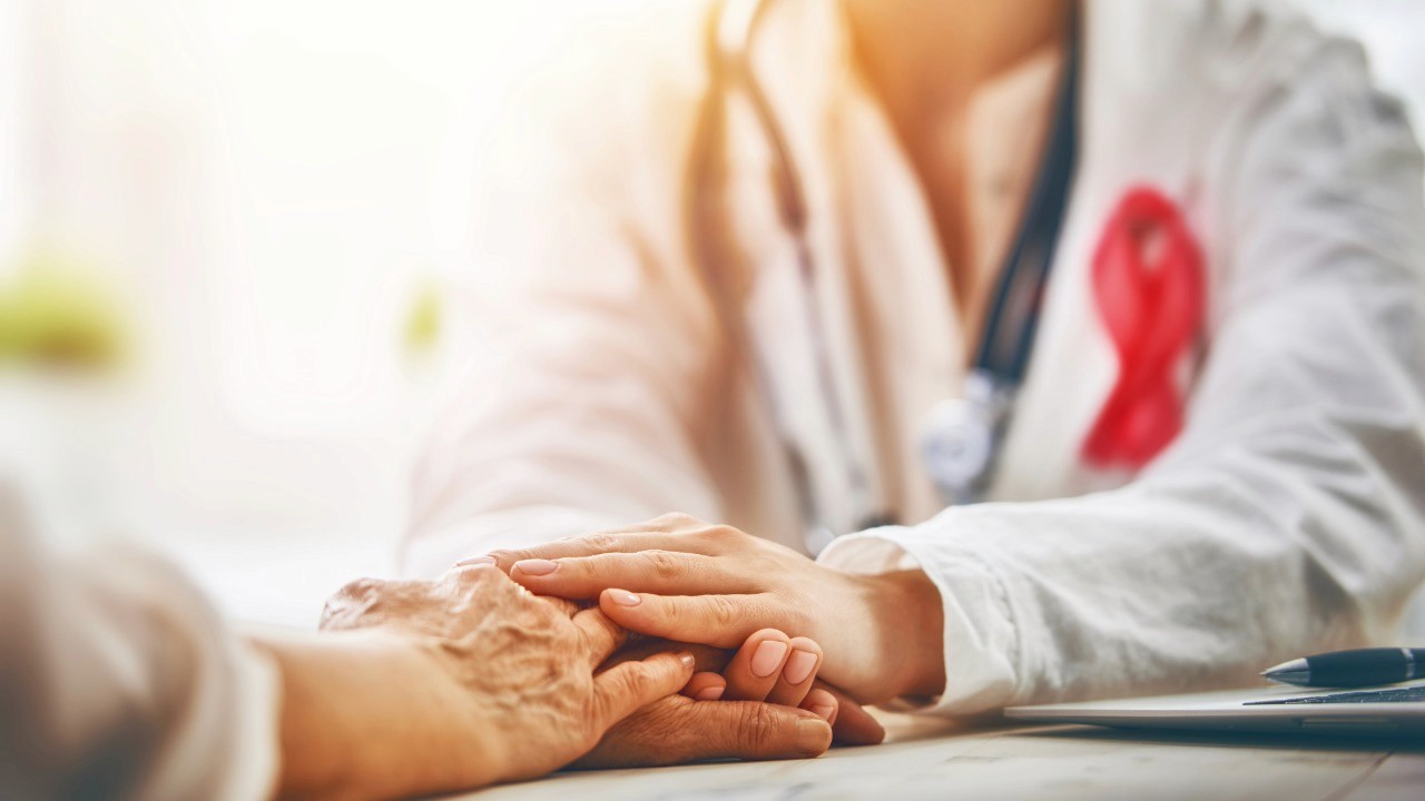 Doctor holding hand of patient